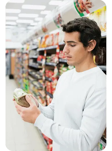 man looking at food product label